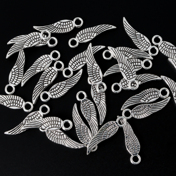 Guardian angel wing charms that are solid and double sided meaning they look the same on the front and back. They are an antiqued silver color.