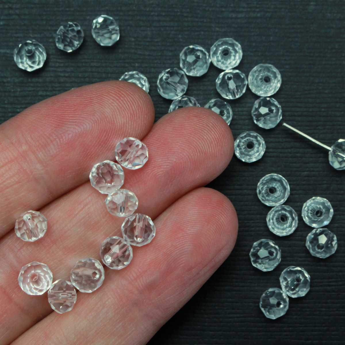 Asian cut crystal glass beads. Clear 6mm round faceted transparent. Sold in packages of 60 beads