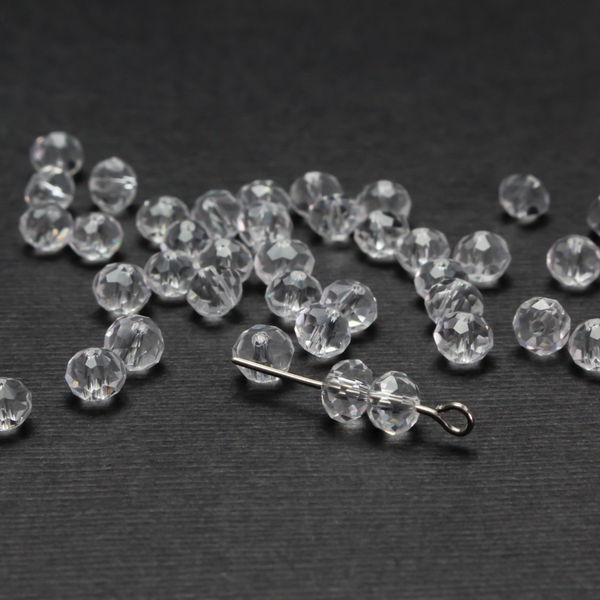 Asian cut crystal glass beads. Clear 6mm round faceted transparent. Sold in packages of 60 beads