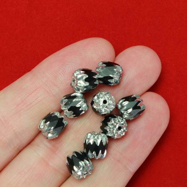 Cathedral shape beads that are faceted. The top and the bottom of the bead are a patterned glass with a silver coating. Made in the Czech Republic. Sold in sets of 20 beads