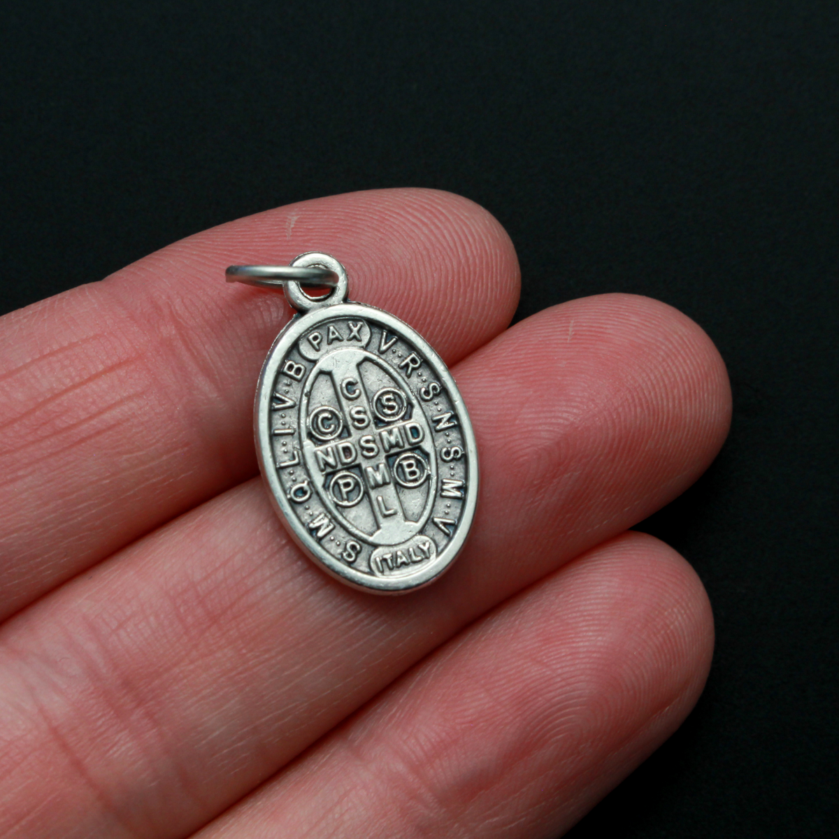 St. Benedict protection medal that depicts the saint on the front. This medal is slightly smaller than our one inch version, it measures 7/8" from the top of the bale to the bottom of the medal