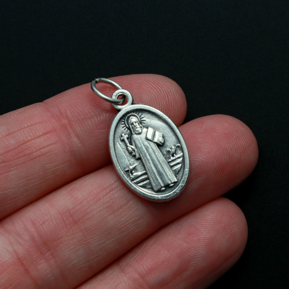 St. Benedict protection medal that depicts the saint on the front. This medal is slightly smaller than our one inch version, it measures 7/8" from the top of the bale to the bottom of the medal