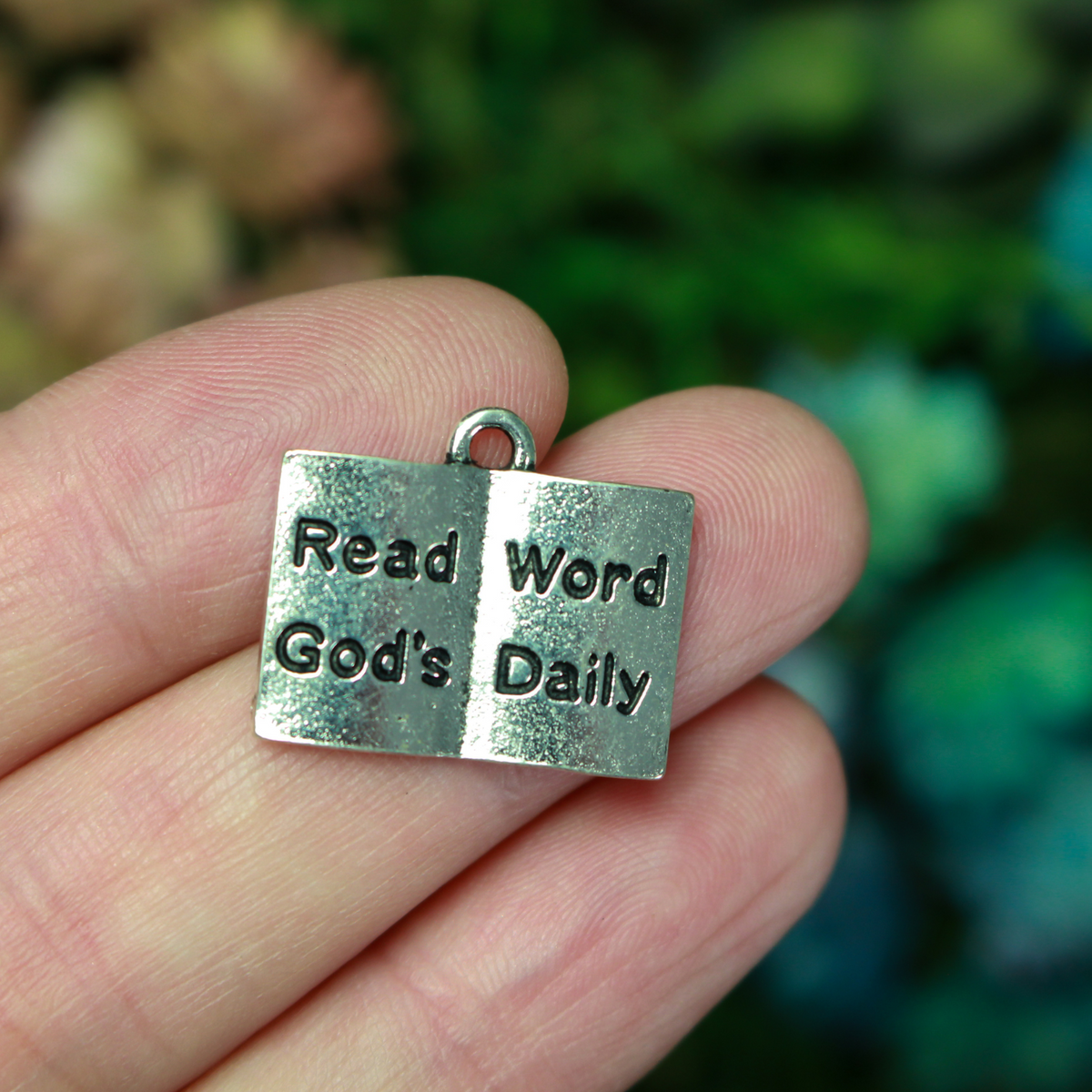 Open book charm with the words "Read God's Word Daily" in black lettering on the open pages