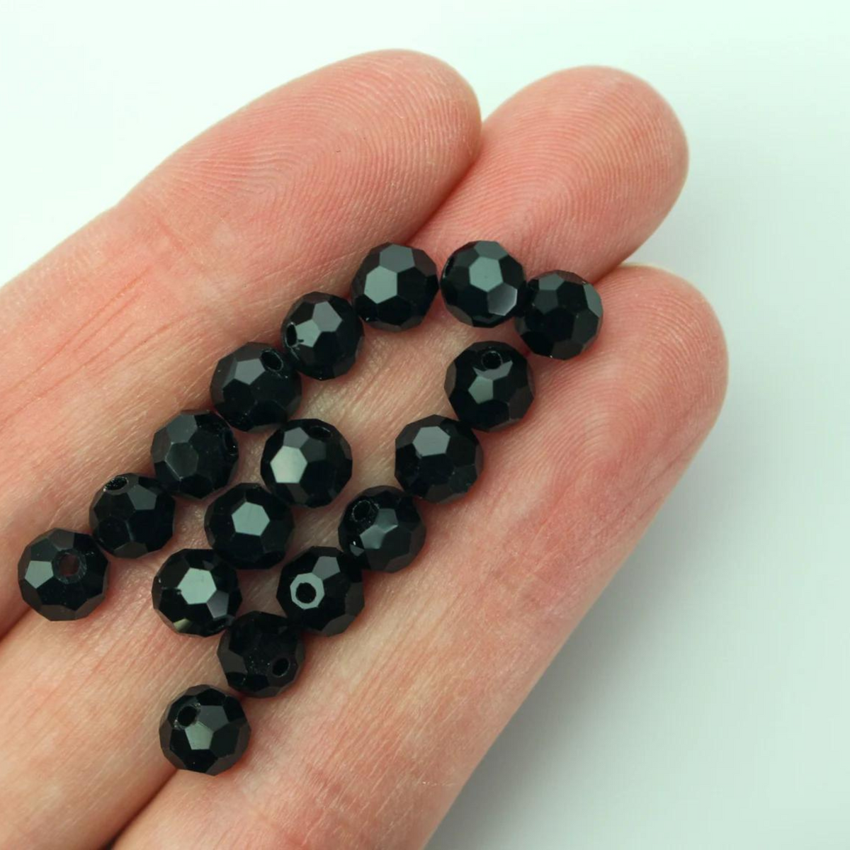 Asian cut crystal glass beads. Black 6mm x 4.4mm faceted. Sold in packages of 60 beads