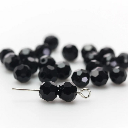 Asian cut crystal glass beads. Black 6mm x 4.4mm faceted. Sold in packages of 60 beads