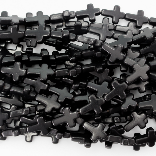 Black cross shaped beads that are a synthetic turquoise material dyed black.