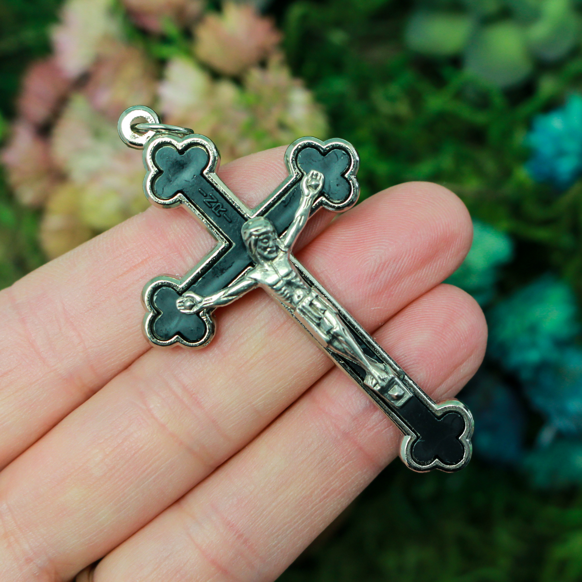 Budded black inlay cloverleaf crucifix with silver corpus and trim, 2.5 inches long