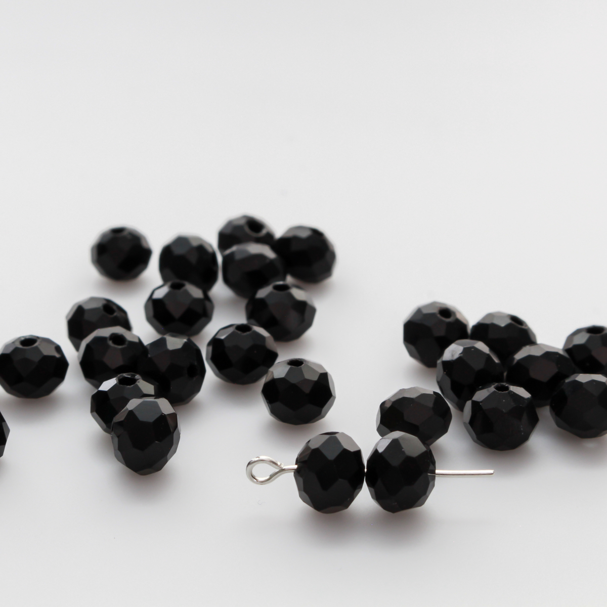 Asian cut crystal glass beads. Black 8mm x 6.2mm rondelle faceted. Sold in packages of 60 beads