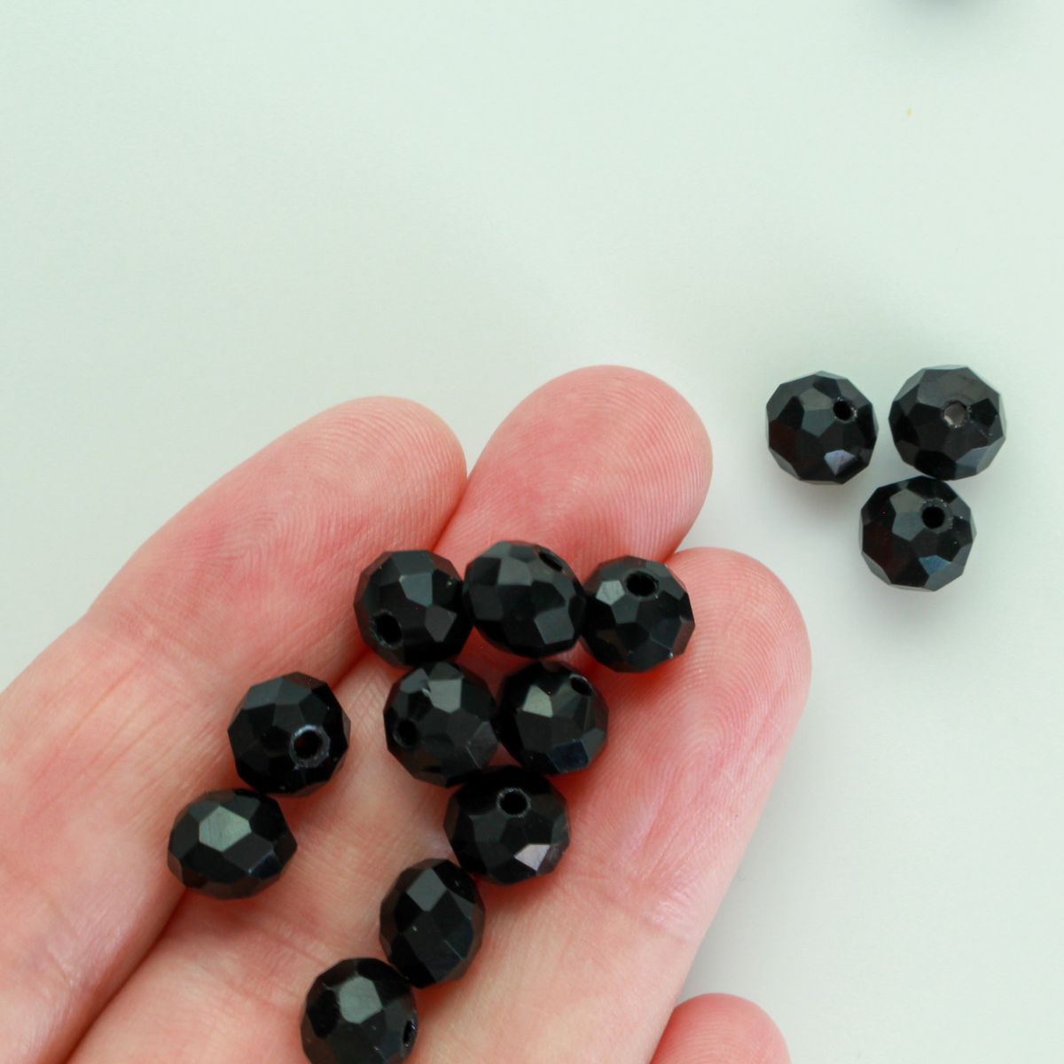 Asian cut crystal glass beads. Black 8mm x 6.2mm rondelle faceted. Sold in packages of 60 beads