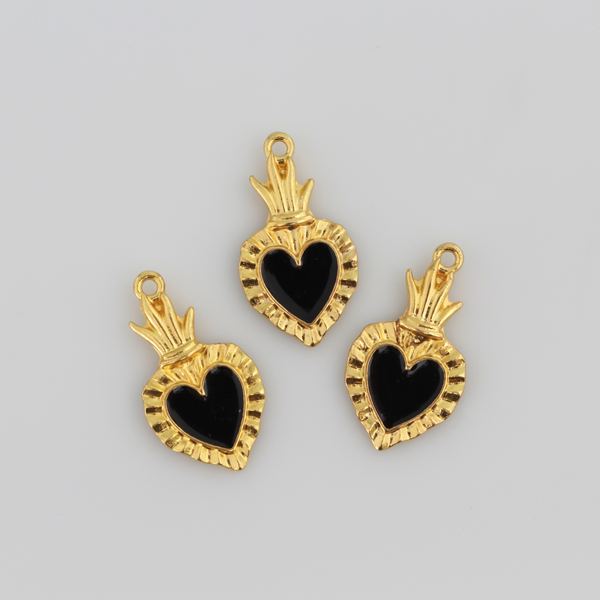 Sacred Heart Ex Voto charms that are a shiny gold color with black enamel detail. 
