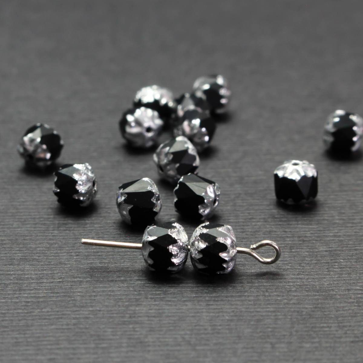 Cathedral shape beads that are faceted. The top and the bottom of the bead are a patterned glass with a silver coating. Made in the Czech Republic. Sold in sets of 20 beads.