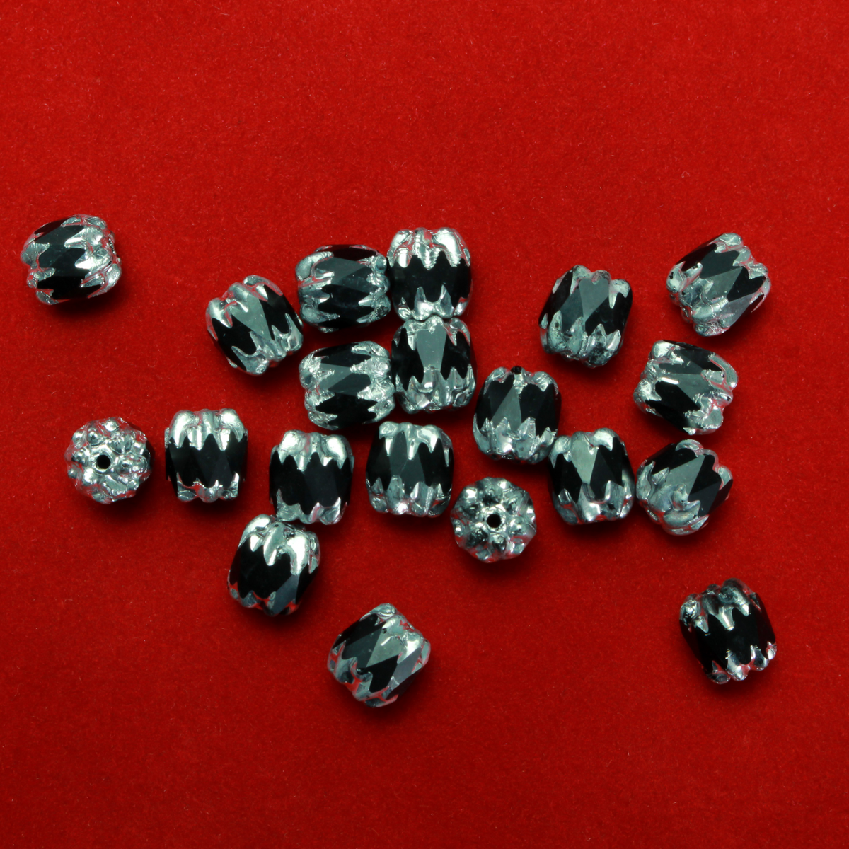 Cathedral shape beads that are faceted. The top and the bottom of the bead are a patterned glass with a silver coating. Made in the Czech Republic. Sold in sets of 20 beads