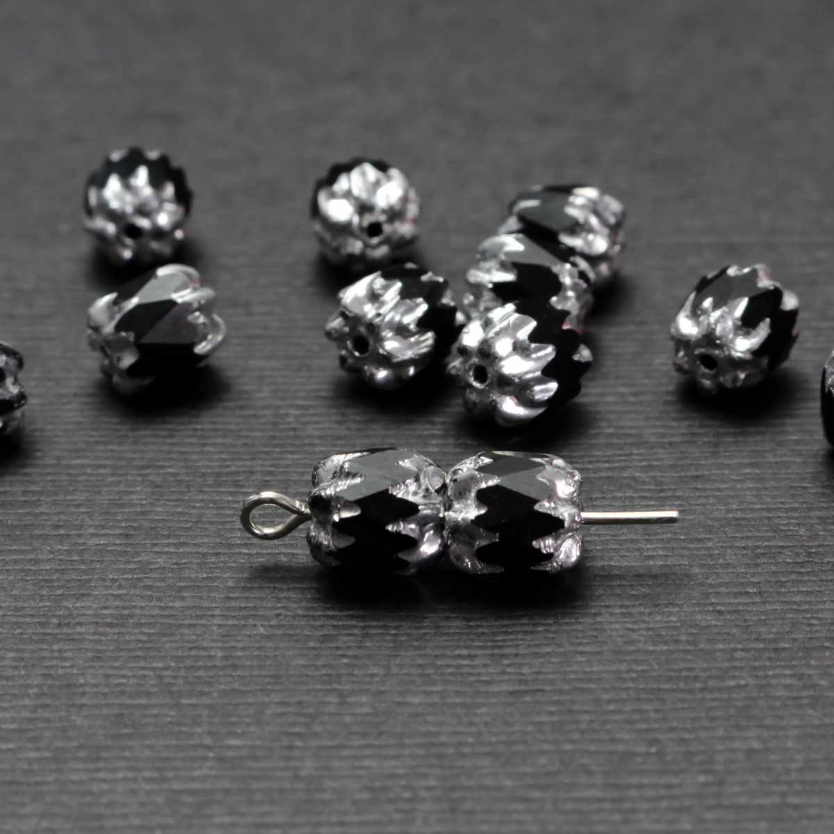 Cathedral shape beads that are faceted. The top and the bottom of the bead are a patterned glass with a silver coating. Made in the Czech Republic. Sold in sets of 20 beads