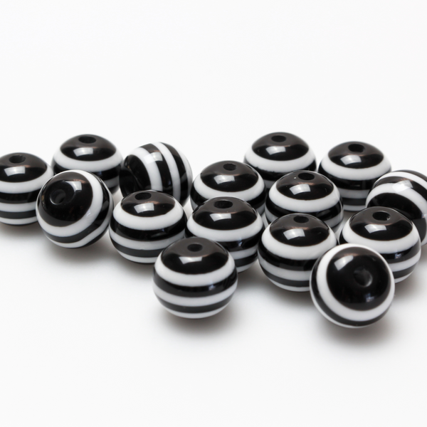 Round black and white striped opaque beads that are 10mm in diameter with a 2mm hole size