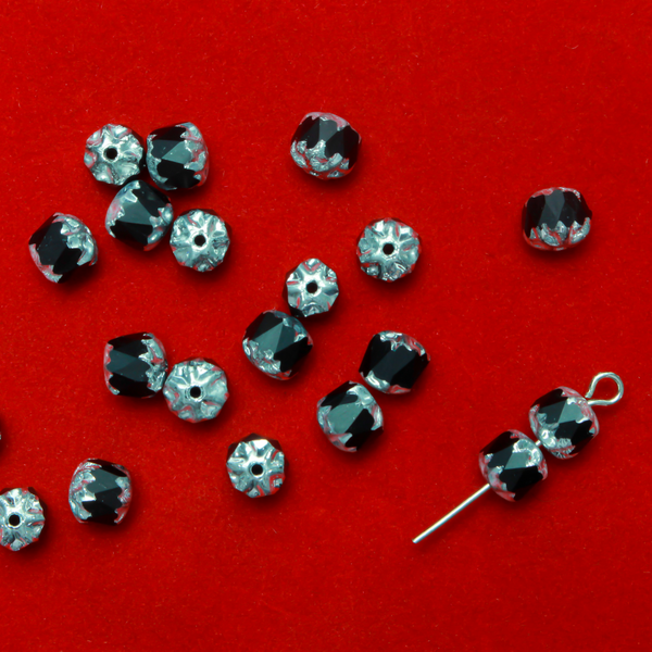 Cathedral shape beads that are faceted. The top and the bottom of the bead are a patterned glass with a silver coating. Made in the Czech Republic. Sold in sets of 20 beads.