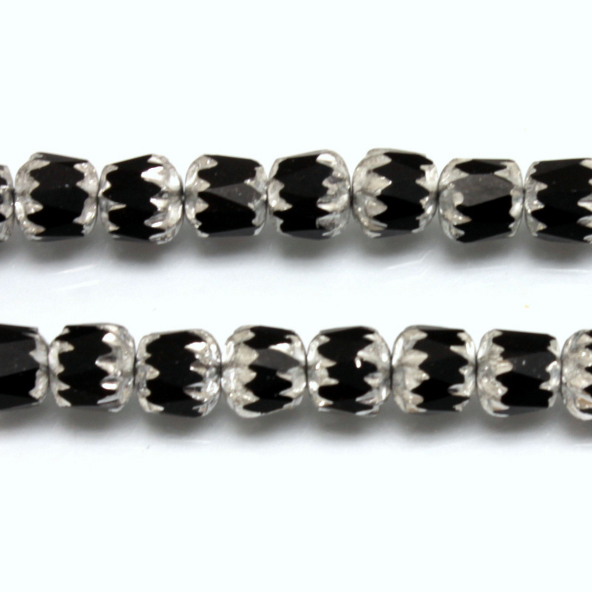 Cathedral shape beads that are faceted. The top and the bottom of the bead are a patterned glass with a silver coating. Made in the Czech Republic. Sold in sets of 20 beads.