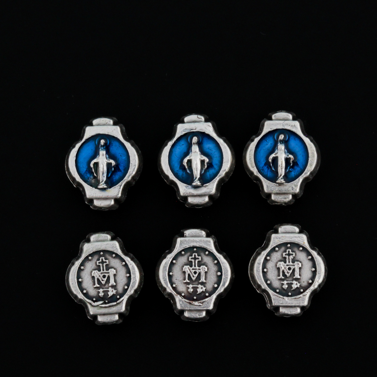Miraculous Medal oval beads that are silver oxidized base metal made in Italy. The front side of the bead has blue enamel detail, the backside does not