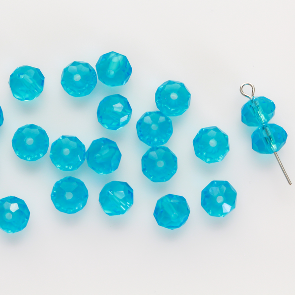 Asian cut crystal glass beads. 8mm x 6.2mm rondelle faceted dark blue transparent. Sold in packages of 60 beads