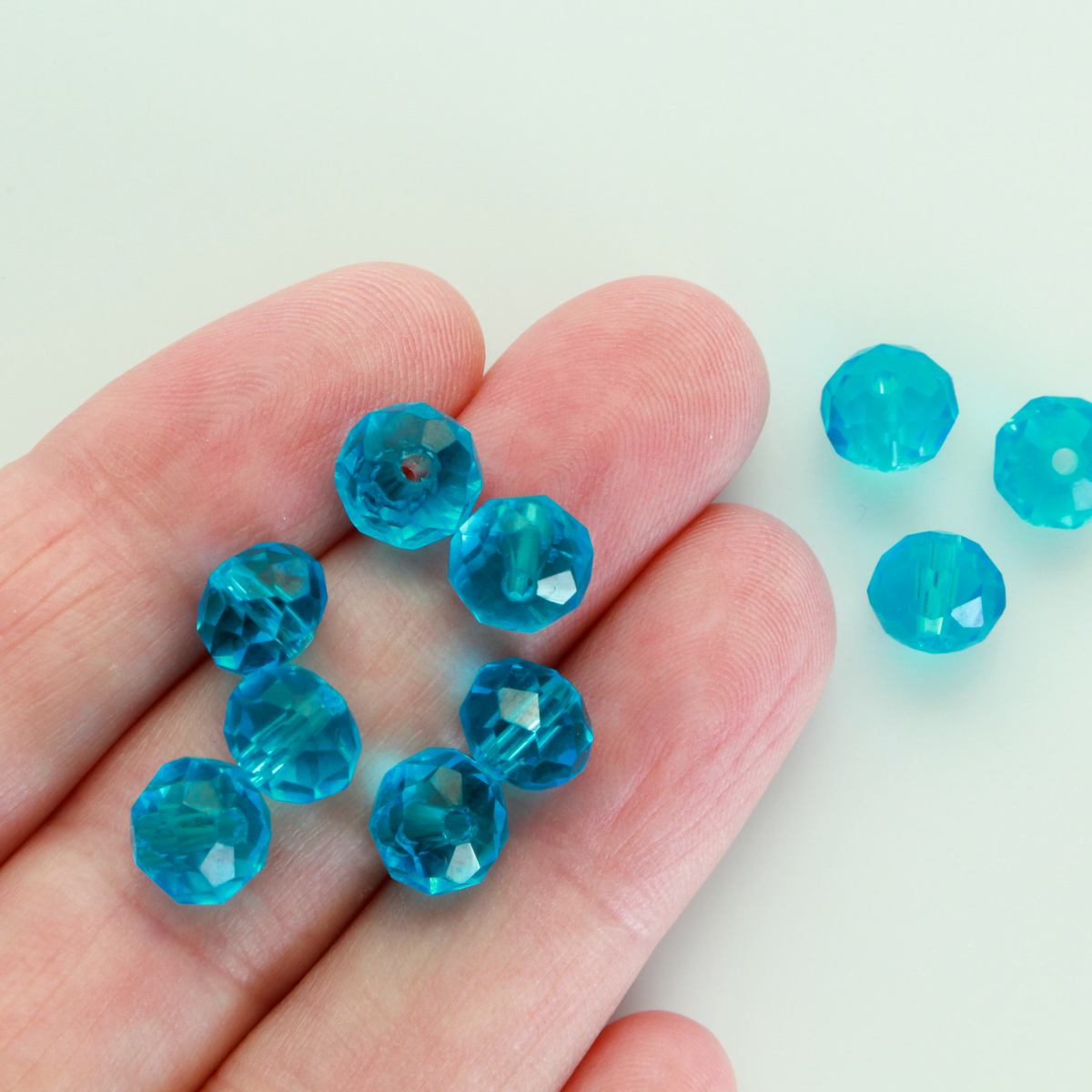 Asian cut crystal glass beads. 8mm x 6.2mm rondelle faceted dark blue transparent. Sold in packages of 60 beads