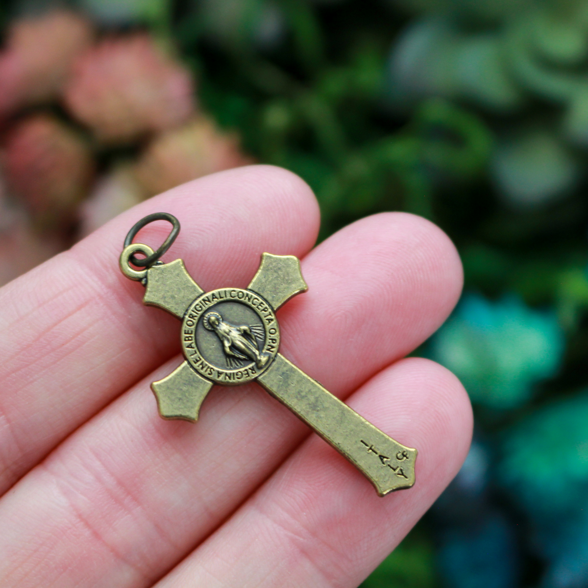 Bronze Miraculous Medal crucifix that features flared edges and a detailed Miraculous Medal, front and back