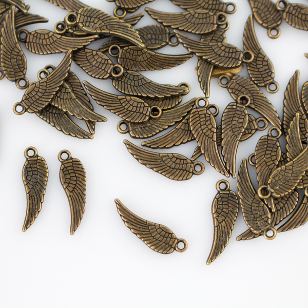 Guardian angel wing charms that are solid and double sided meaning they look the same on the front and back. They are an antiqued bronze color.