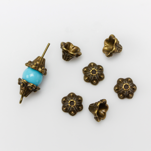 Bell flower shaped bead caps that will fit beads 8mm - 10mm. Shown on an 8mm glass bead for size reference. Sold in packages of 50 caps