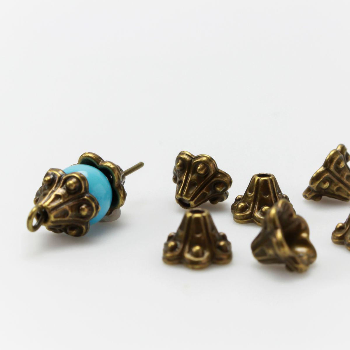 Bell flower shaped bead caps that will fit beads 8mm - 10mm. Shown on an 8mm glass bead for size reference. Sold in packages of 50 caps