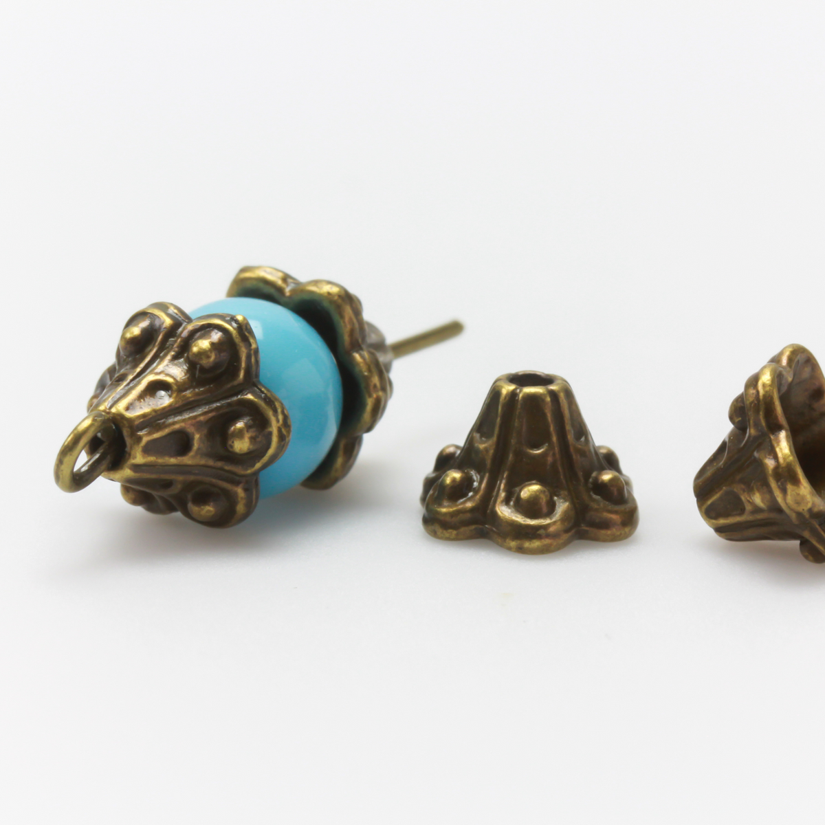 Bell flower shaped bead caps that will fit beads 8mm - 10mm. Shown on an 8mm glass bead for size reference. Sold in packages of 50 caps