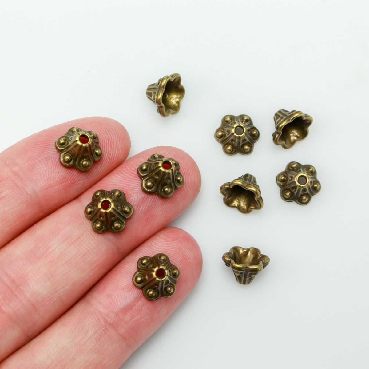 Bell flower shaped bead caps that will fit beads 8mm - 10mm. Shown on an 8mm glass bead for size reference. Sold in packages of 50 caps