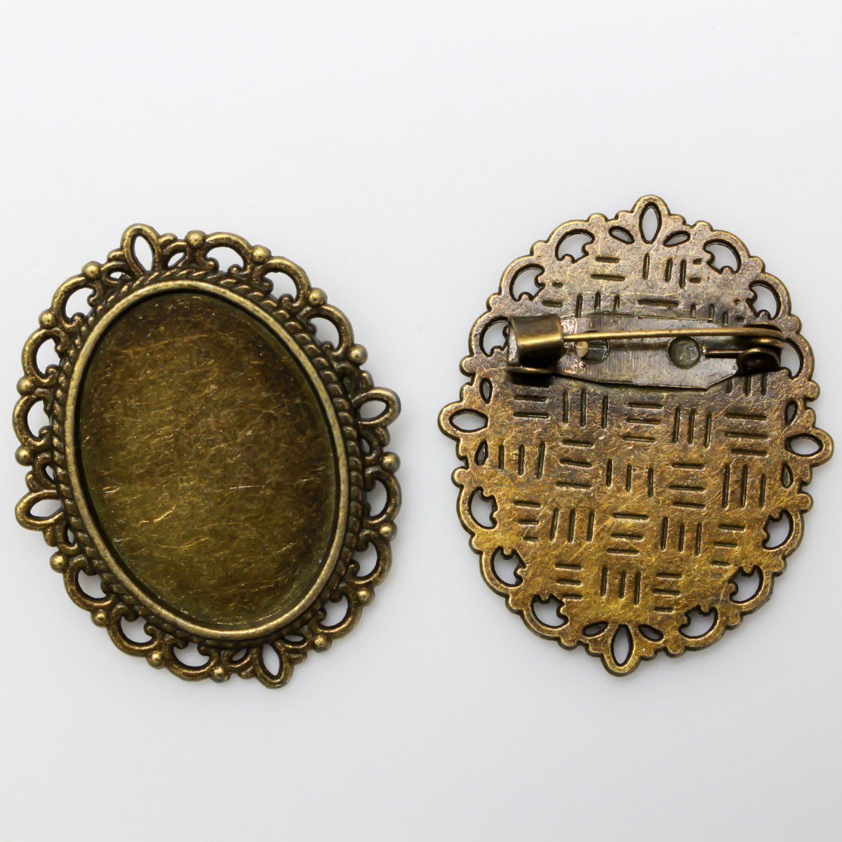 Bronze oval bezel brooch pin with an ornate filigree border. The tray size on this bezel is 25mm x 18mm
