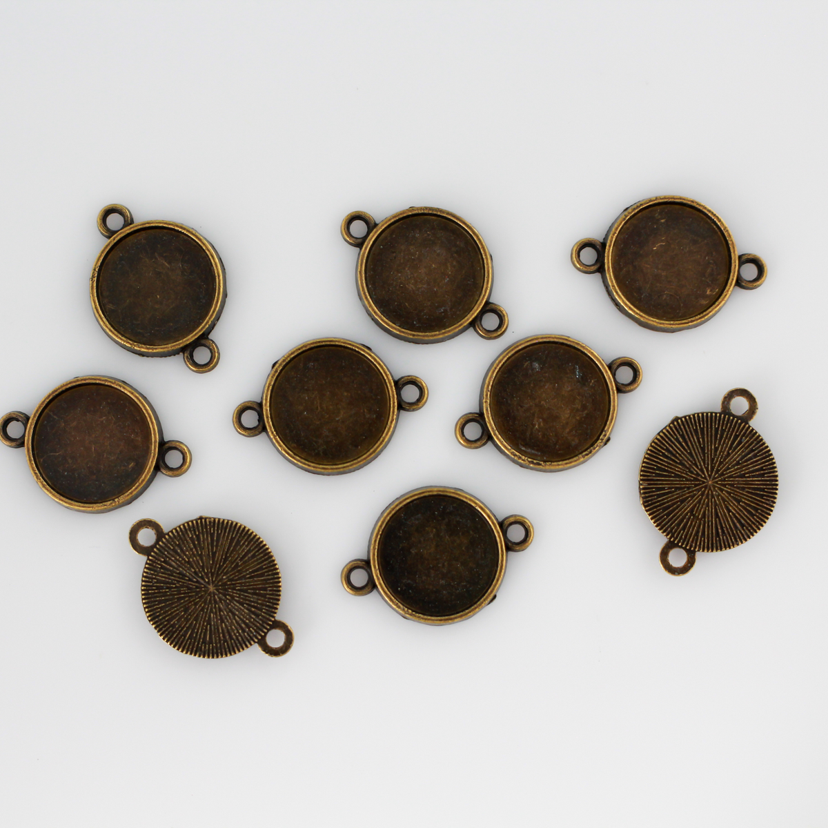 Antiqued bronze bezel cup that has a bail on two sides which makes them perfect for connector links in bracelets or Pater beads on a rosary