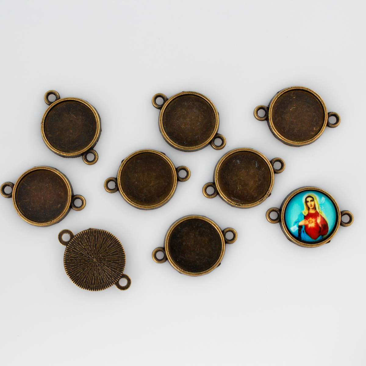 Antiqued bronze bezel cup that has a bail on two sides which makes them perfect for connector links in bracelets or Pater beads on a rosary
