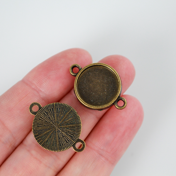Antiqued bronze bezel cup that has a bail on two sides which makes them perfect for connector links in bracelets or Pater beads on a rosary