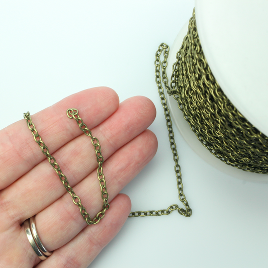 Iron cable chain that has soldered links that are oval in shape and antiqued bronze color. Sold in lengths of 5 feet.