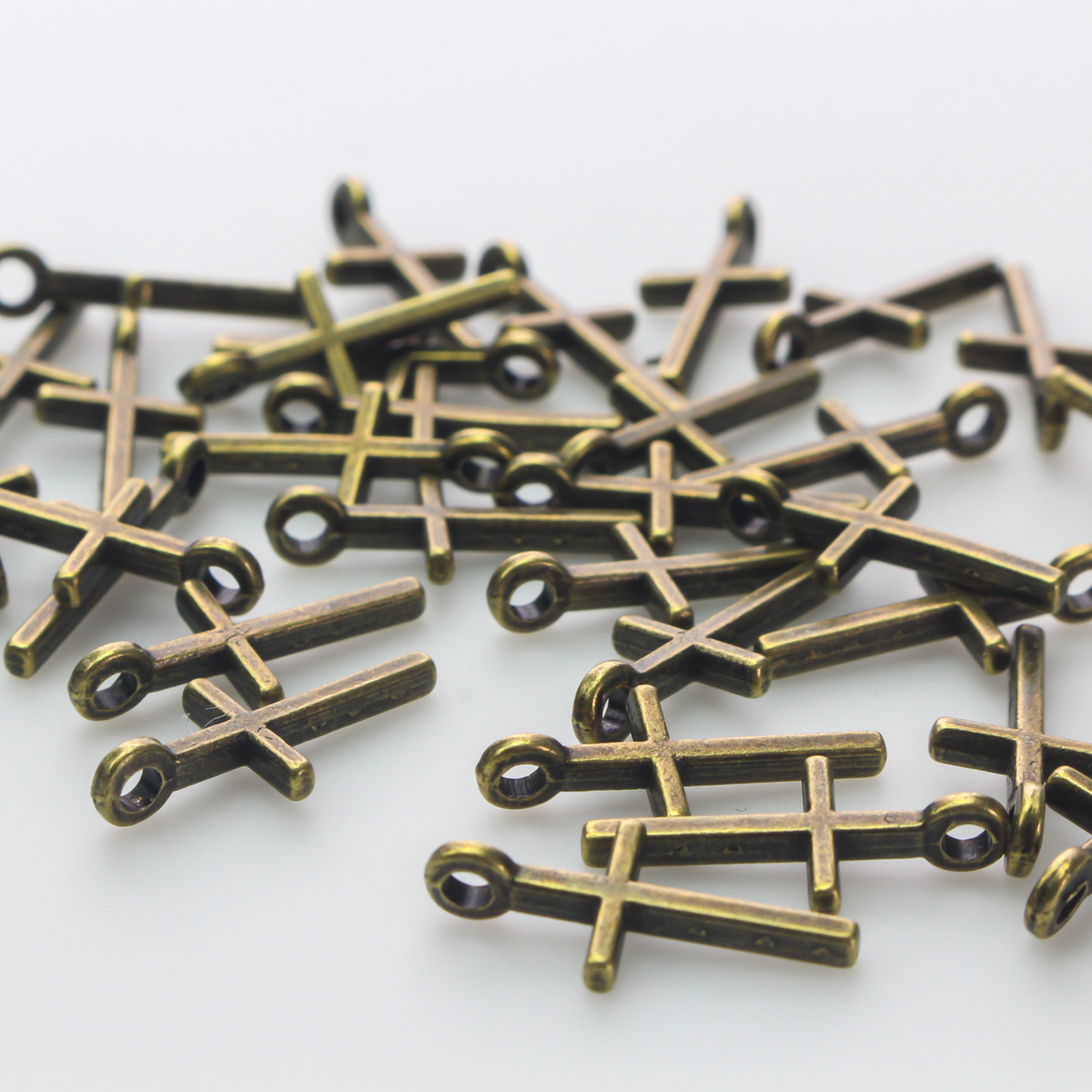 simple bronze cross charm 17mm long
