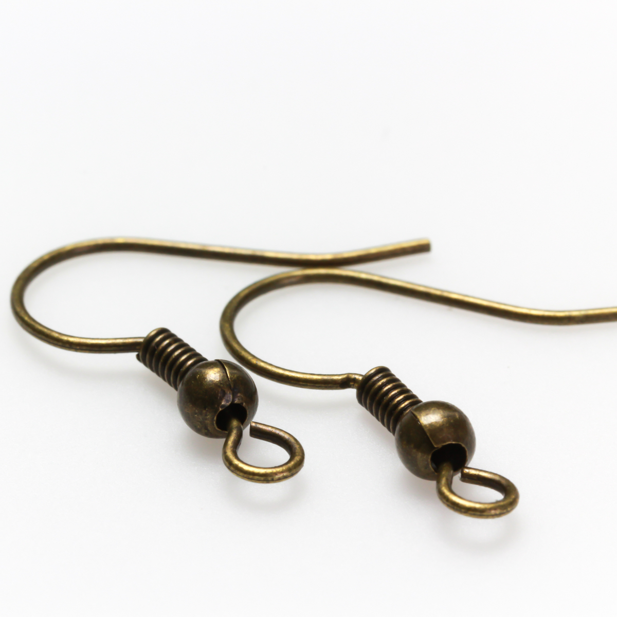 Brass earring hooks with a horizontal loop and an antiqued bronze finish. 23 gauge wire. Sold in packages of 30 hooks (15 pairs).