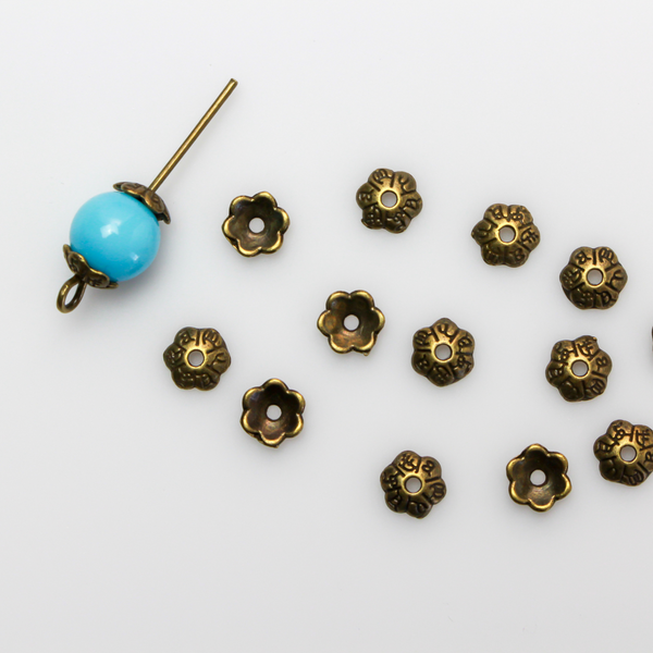 Flower shaped zinc alloy antiqued bronze bead caps that are 6mm in diameter. They can fit beads 6mm - 10mm