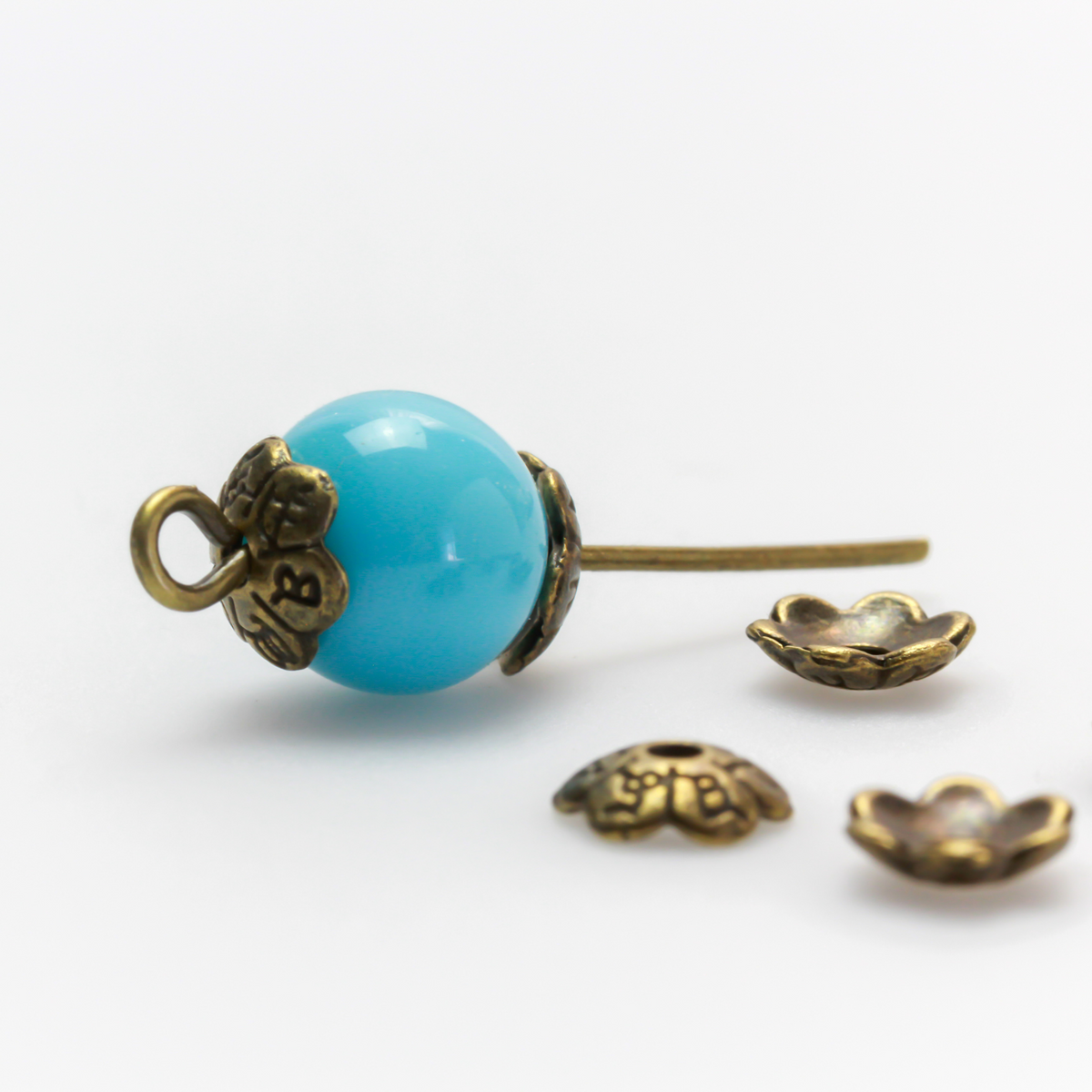 Flower shaped zinc alloy antiqued bronze bead caps that are 6mm in diameter. They can fit beads 6mm - 10mm