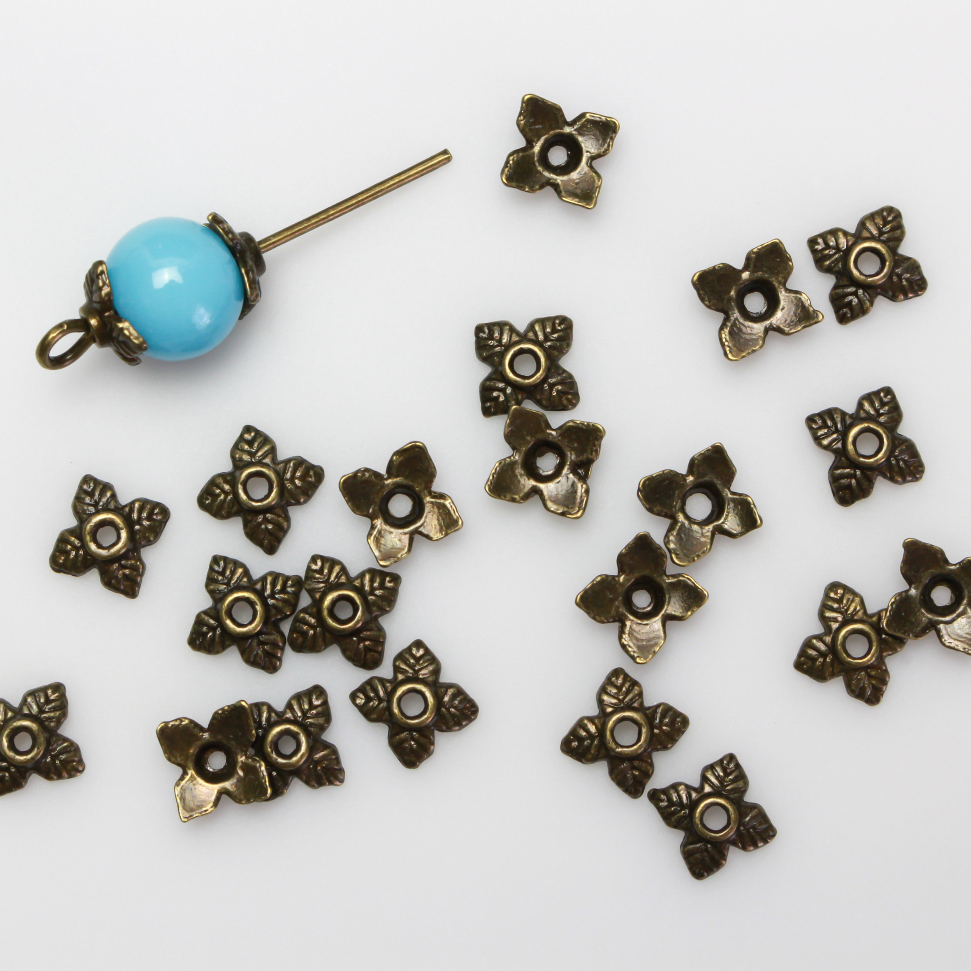 Bronze leaf shaped bead caps with a four leaf pattern, 6mm with a 1mm hole. Sold in packages of 120 pieces.