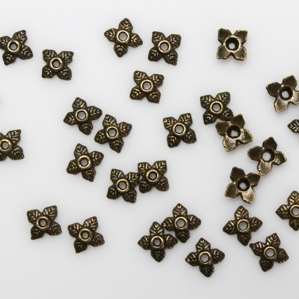 Bronze leaf shaped bead caps with a four leaf pattern, 6mm with a 1mm hole. Sold in packages of 120 pieces.