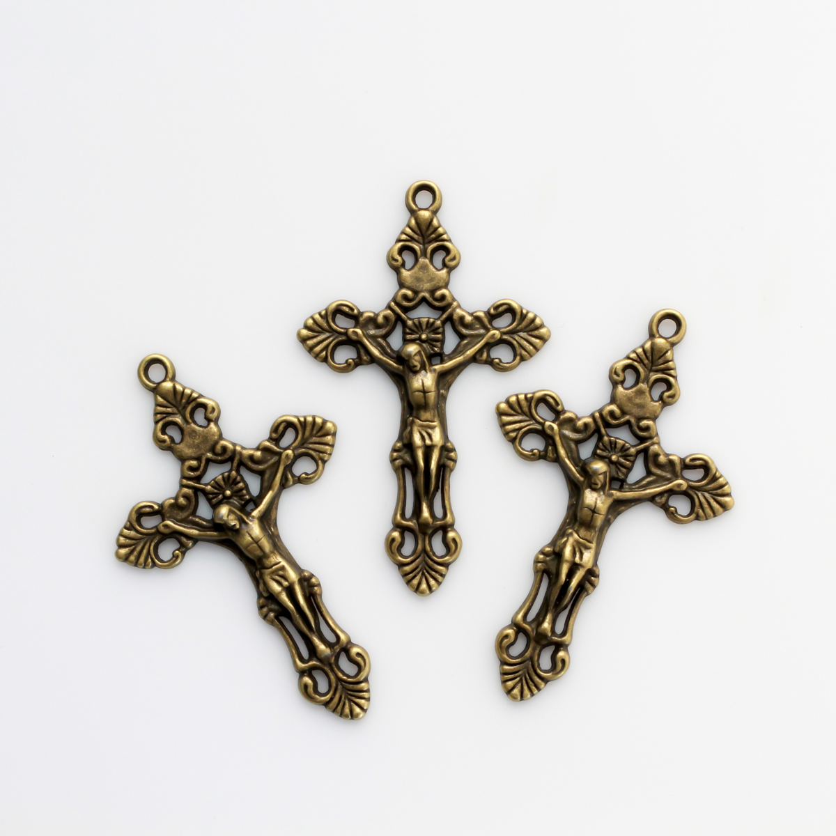 Three ornate fleur de lis crucifix cross in an antiqued bronze color and filigree cut out design, 2-1/8" long