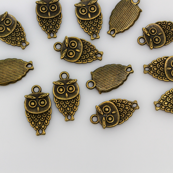 Small owl charm in an antiqued bronze tone color, 18mm long