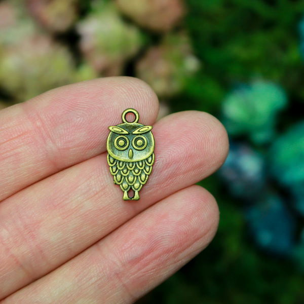 Small owl charm in an antiqued bronze tone color, 18mm long
