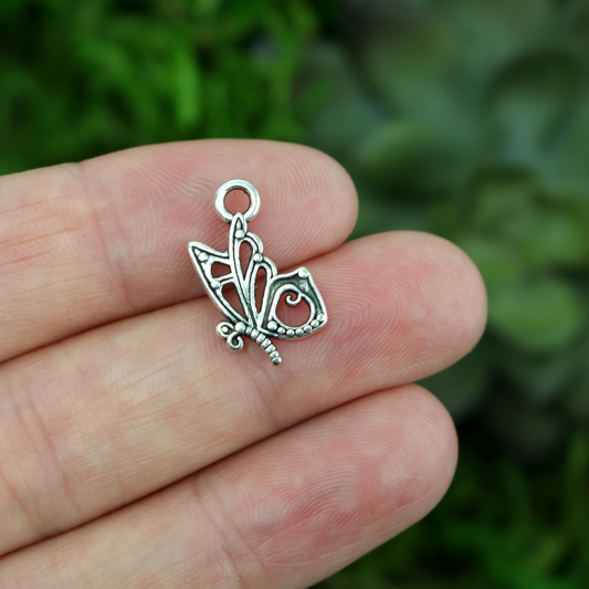 butterfly charm that is silver in color