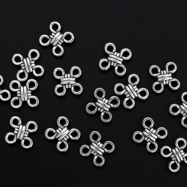 Silver Celtic knot shaped connectors. These are flat connector links with four connectors, one on each corner, 12mm