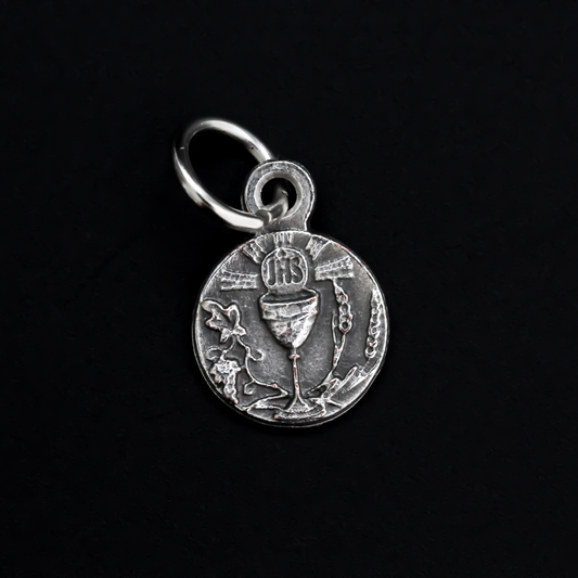 Mini medal that depicts a chalice in the center with wheat on one side and grapes on the other and the Holy Eucharist at the top