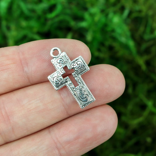 ornate cross charm with cutout cross in center