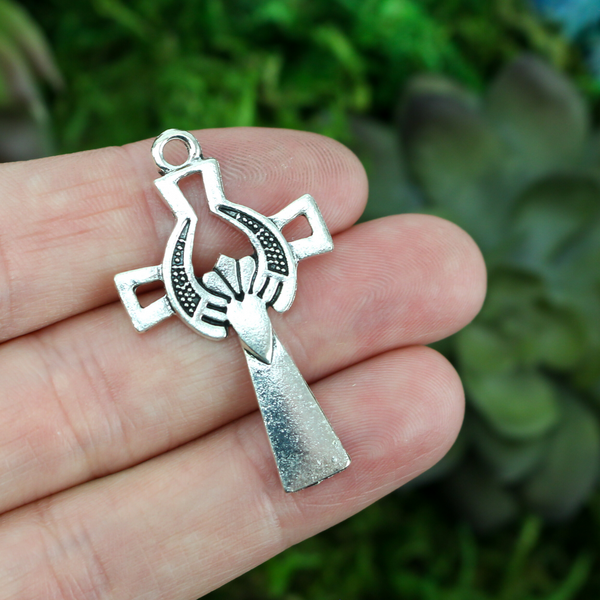 silver tone cross pendant with claddagh symbol