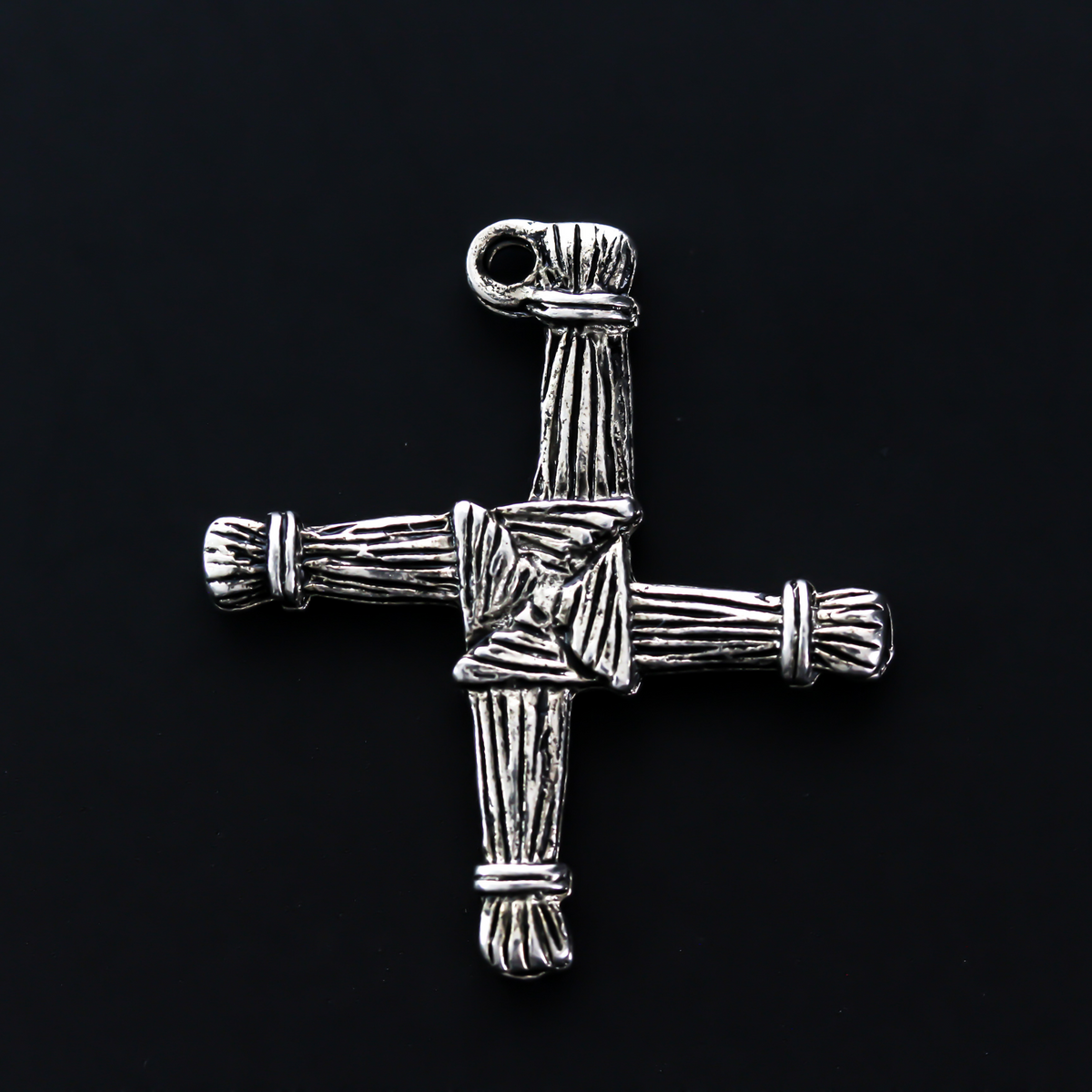 Brigid's cross charm 1-1/8" long The cross is an antiqued silver-tone color and looks the same on both sides. There is no jump ring attached to the bail