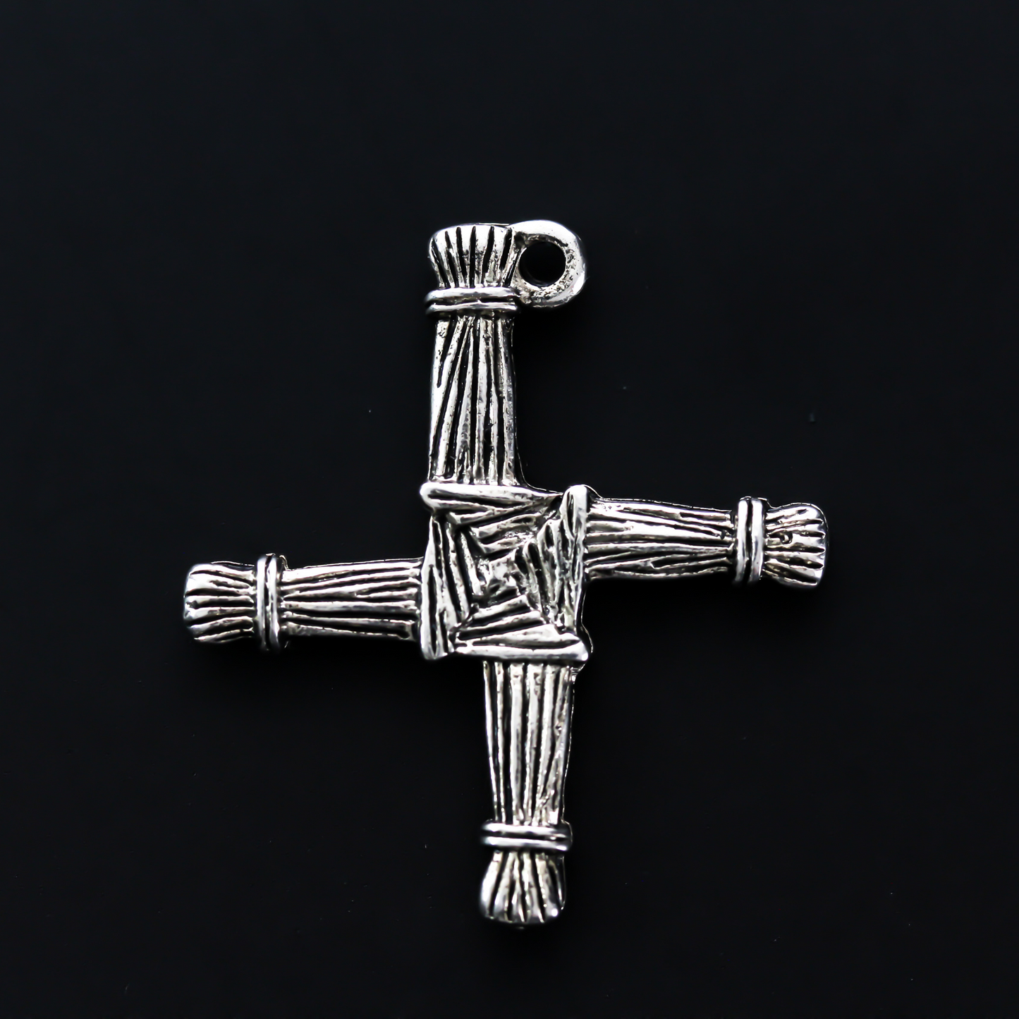 Brigid's cross charm 1-1/8" long The cross is an antiqued silver-tone color and looks the same on both sides. There is no jump ring attached to the bail